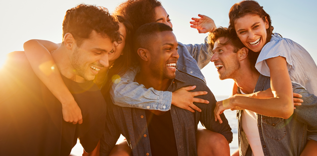 diverse group of friends, three adult men carrying three adult women piggyback